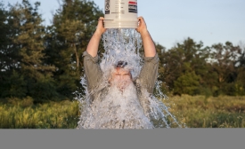 A man accepts the ALS Ice Bucket Challenge