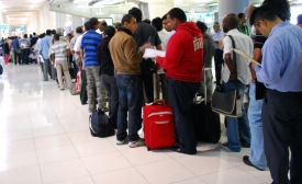 Travelers to Bangkok wait on line for visas