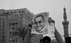 A protestor in Tahrir Square, Cairo, holds up a portrait of former President Nasir, 2011