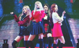 Photo: K-pop group member Lisa (Lalisa Manobal, center) is of Thai origin and was praised by Thai Prime Minister Prayut Chan-o-cha for featuring Thai culture in a popular music video. (Photo by oAQeyGW via Flickr.)