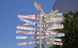 Sign in downtown Los Angeles indicating sister cities with country flags, distances and directions by Pmlineditor via Wikimedia Commons