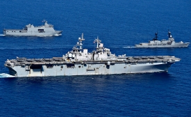 South China Sea: USS Wasp (LHD 1) maneuvers with Philippine Navy ships.