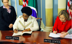 U.S. Secretary of State Hillary Rodham Clinton and South African Minister Maite Nkoana-Mashabane sign the PEPFAR Partnership Framework Agreement