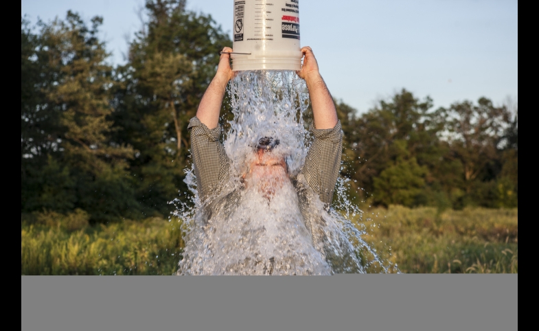 A man accepts the ALS Ice Bucket Challenge