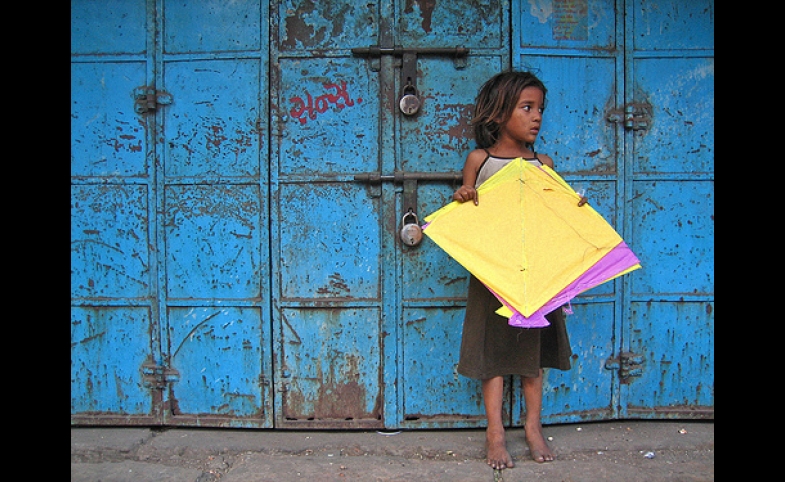 Yellow Patang. A girl from the nearby slum collecting fallen kites (patang) at Manek Chowk in the Old City.