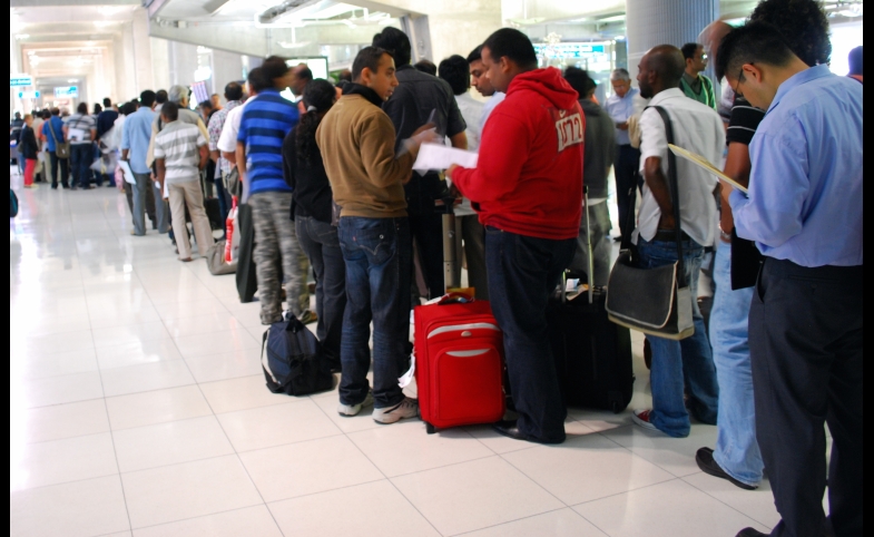 Travelers to Bangkok wait on line for visas