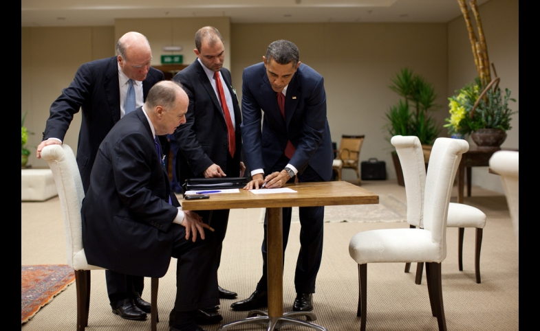 Ben Rhodes stands next to President Barack Obama