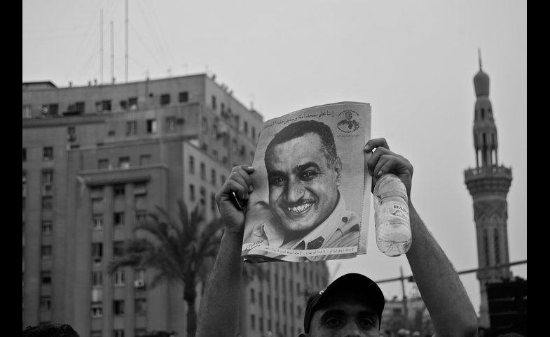 A protestor in Tahrir Square, Cairo, holds up a portrait of former President Nasir, 2011