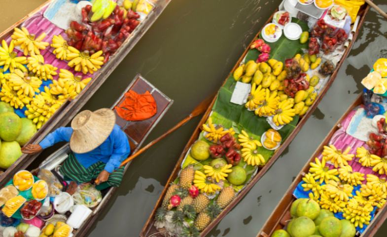 image of floating market in bangkok by izzetugutmen via Canva