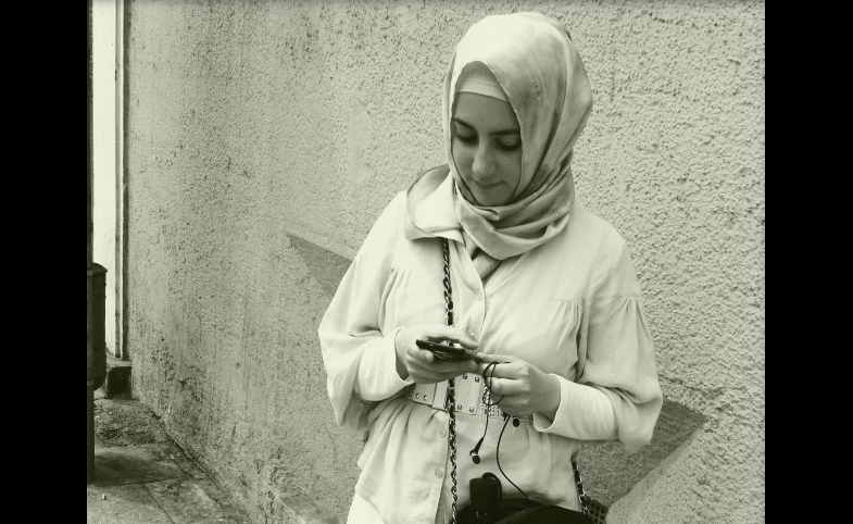 A young woman checks her smart phone