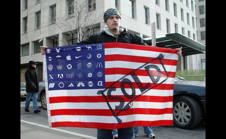 A protester holds Adbuster's American Corporate flag