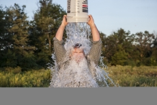 A man accepts the ALS Ice Bucket Challenge
