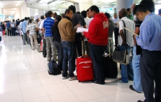 Travelers to Bangkok wait on line for visas