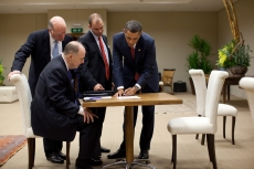 Ben Rhodes stands next to President Barack Obama