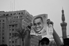 A protestor in Tahrir Square, Cairo, holds up a portrait of former President Nasir, 2011