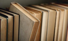 Old books with one selected by Racool_studio via freepik.com