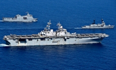 South China Sea: USS Wasp (LHD 1) maneuvers with Philippine Navy ships.