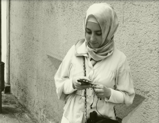 A young woman checks her smart phone