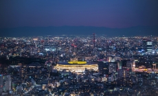 Overhead aerial view of the new National Stadium with Tokyo's skyline in twilight time, fully completed main stadium for Tokyo Olympic Summer Games 2020. Image via iStock. Overhead aerial view of the new National Stadium with Tokyo's skyline in twilight time, fully completed main stadium for Tokyo Olympic Summer Games 2020. Image via iStock.