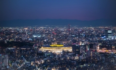 Overhead aerial view of the new National Stadium with Tokyo's skyline in twilight time, fully completed main stadium for Tokyo Olympic Summer Games 2020. Image via iStock.