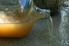 Dirty water spilling from a bottle, by Ildar Sagdejev