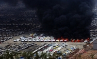 Cars burn in Tianjin after the explosion