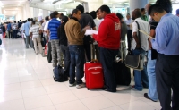 Travelers to Bangkok wait on line for visas