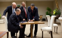 Ben Rhodes stands next to President Barack Obama